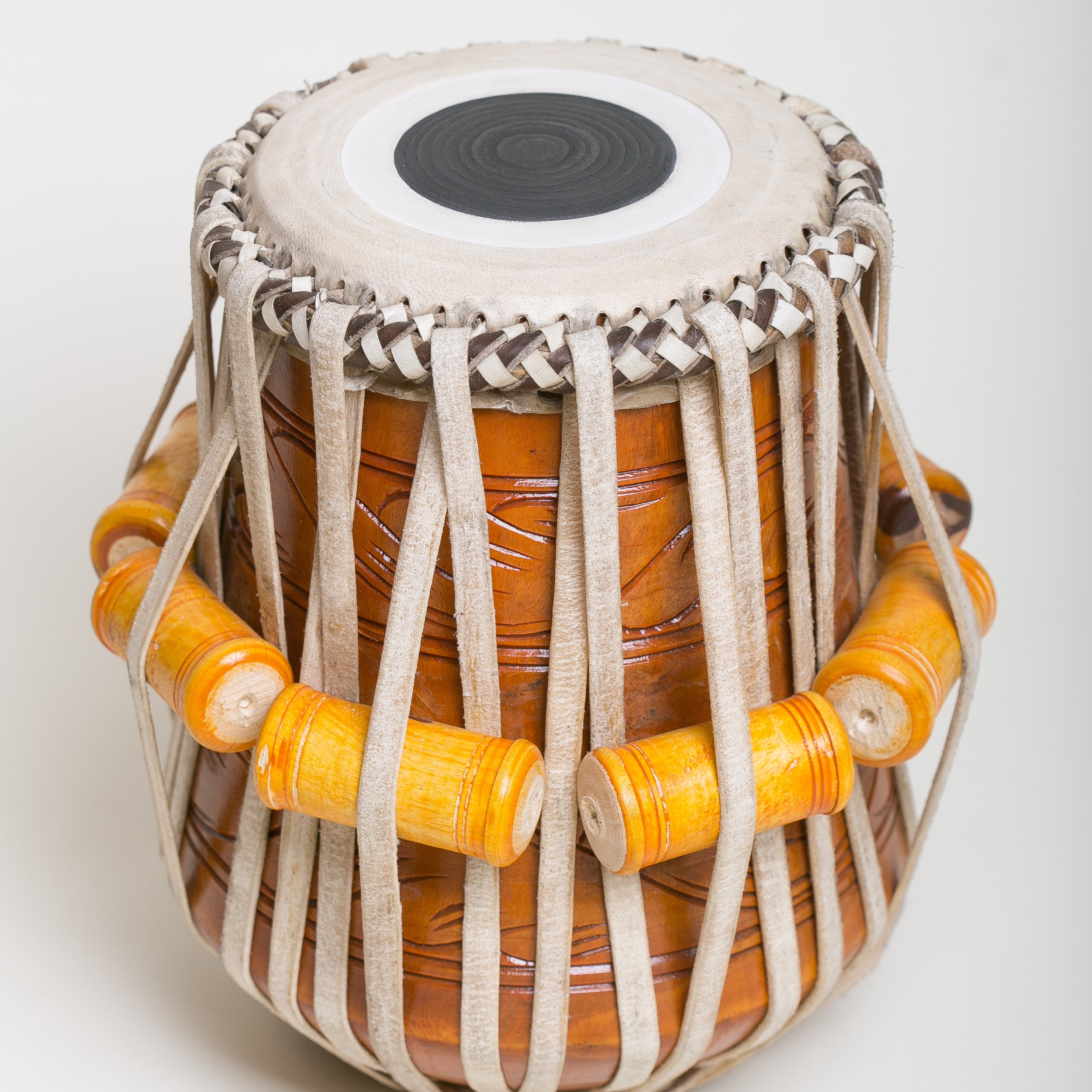 A custom carved wooden dayan tabla